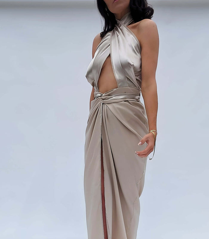 Woman wearing a beautiful halter neck champagne satin dress with a wrap waist