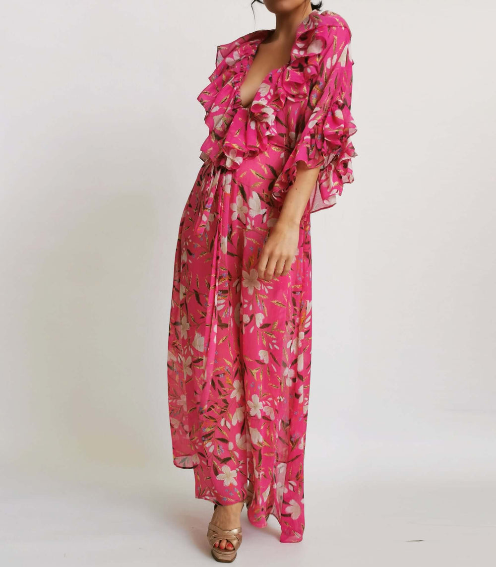  A model in a pink floral print dress posing for a photoshoot.