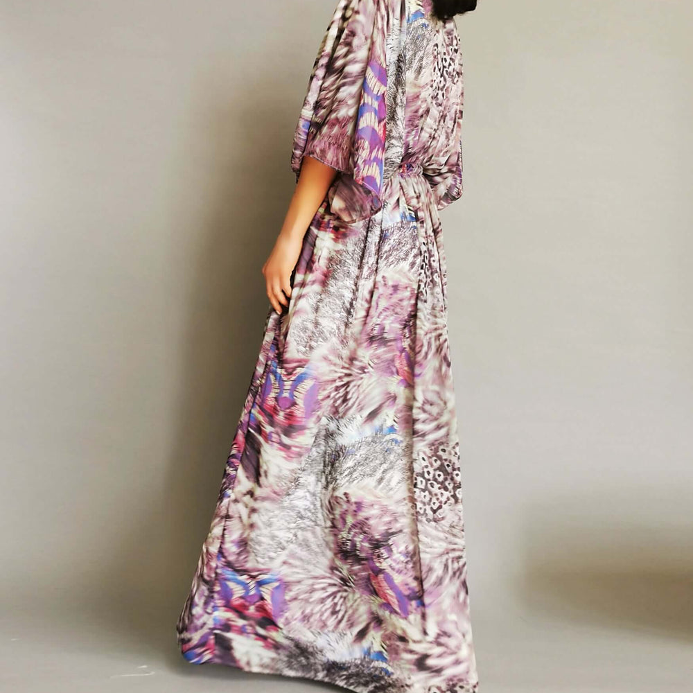 
                      
                        The model looks stunning in a purple and pink floral print dress, radiating beauty and elegance.
                      
                    