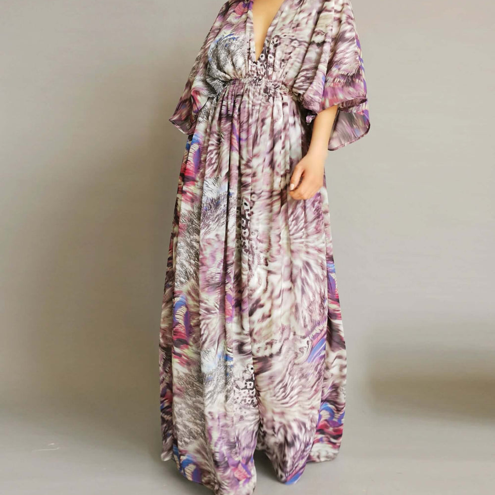 
                      
                        A chic model wearing a purple and pink floral print dress, embodying poise and glamour.
                      
                    